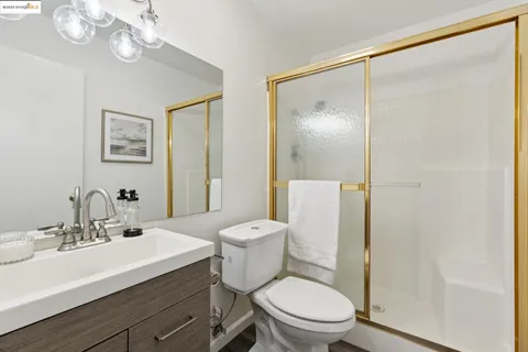 a bathroom with a toilet a sink and a mirror