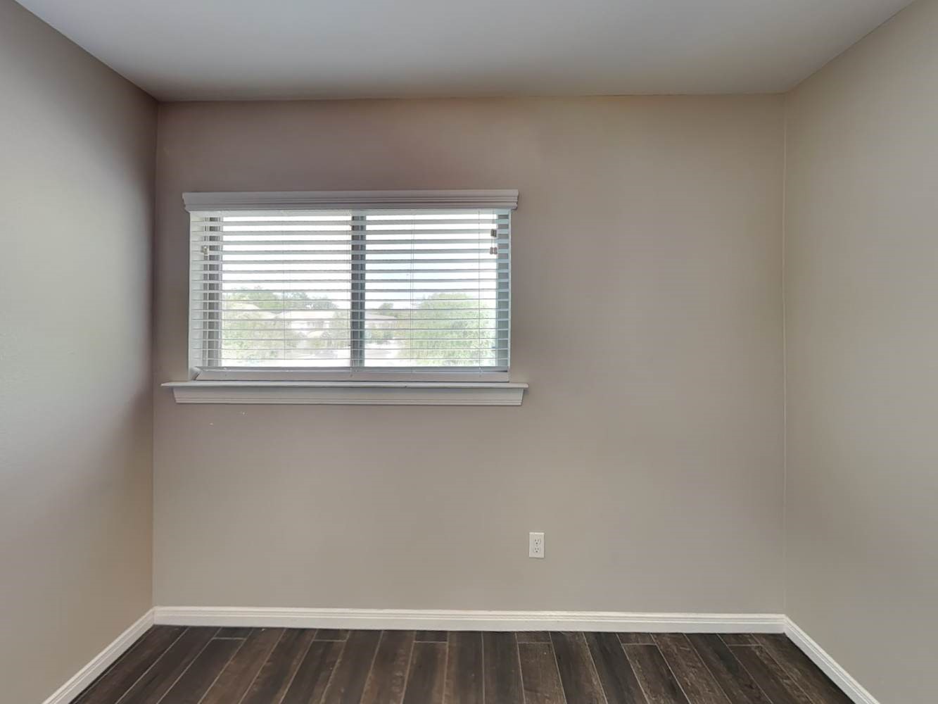 179 Holly Street, Unit 102 Georgetown, TX 78626 - Photo 13 of 17 an empty room with wooden floor and windows