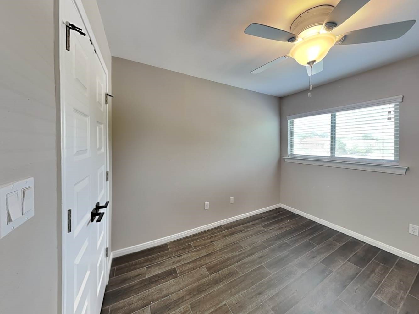 179 Holly Street, Unit 102 Georgetown, TX 78626 - Photo 14 of 17 wooden floor in an empty room with a window