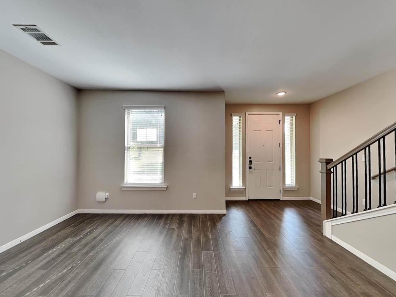 179 Holly Street, Unit 102 Georgetown, TX 78626 - Photo 3 of 17 a view of an empty room with wooden floor and a window
