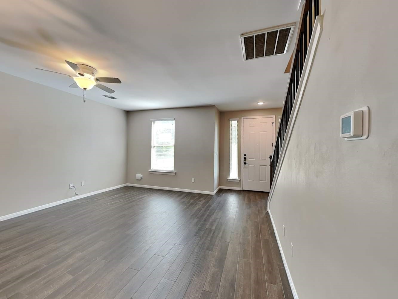 179 Holly Street, Unit 102 Georgetown, TX 78626 - Photo 4 of 17 a view of an empty room with wooden floor and a window
