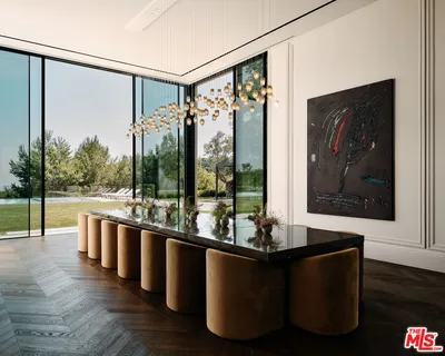 a living room with patio furniture and a chandelier