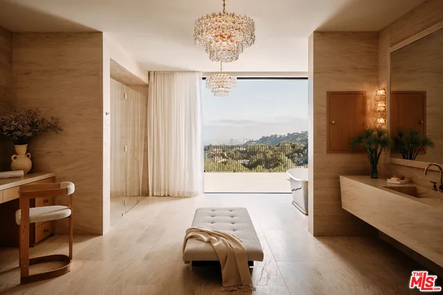 a living room with patio furniture and a chandelier