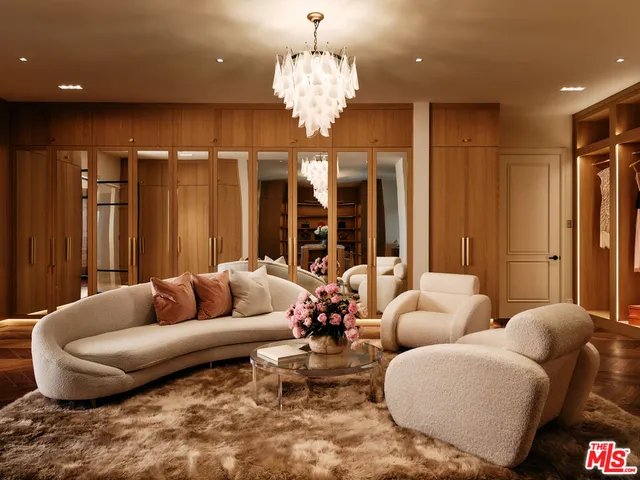 a view of hall way with furniture and chandelier