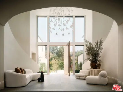 a living room with large window and a wooden floor