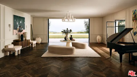 a living room with furniture a chandelier and a fireplace