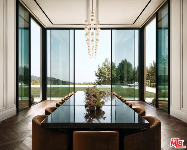 a view of living room with couch and floor to ceiling windows