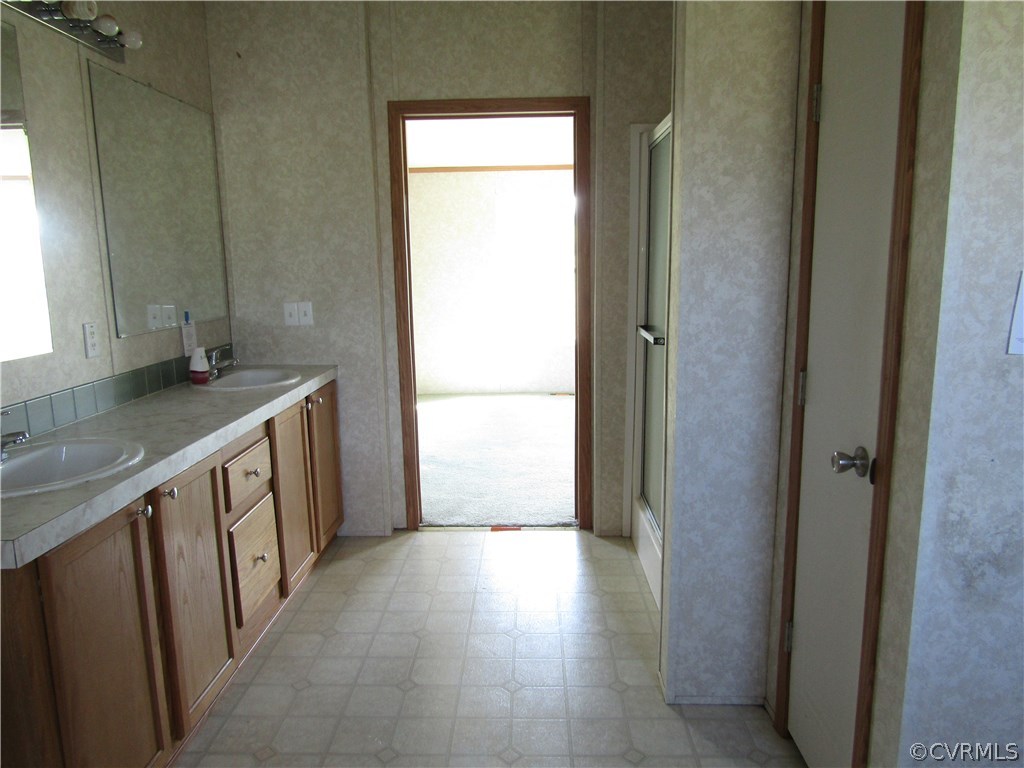 17622 Fox Branch Road Carson, VA 23830 - Photo 12 of 30 a bathroom with a granite countertop sink and a mirror