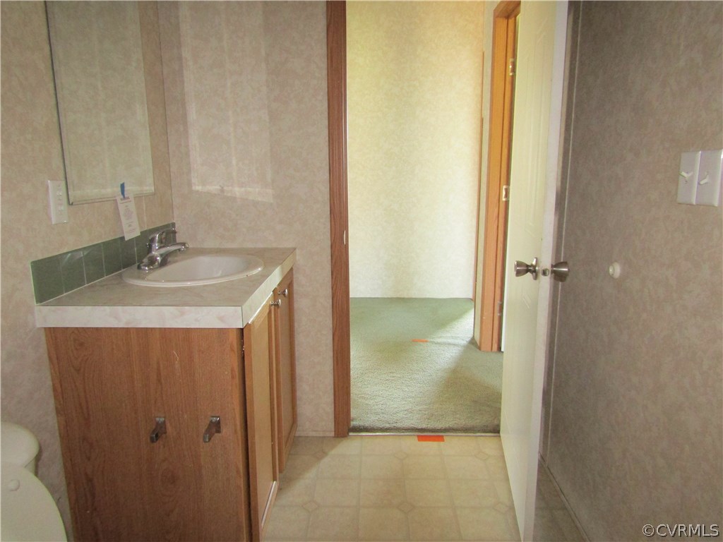 17622 Fox Branch Road Carson, VA 23830 - Photo 30 of 30 a bathroom with a granite countertop sink and a mirror