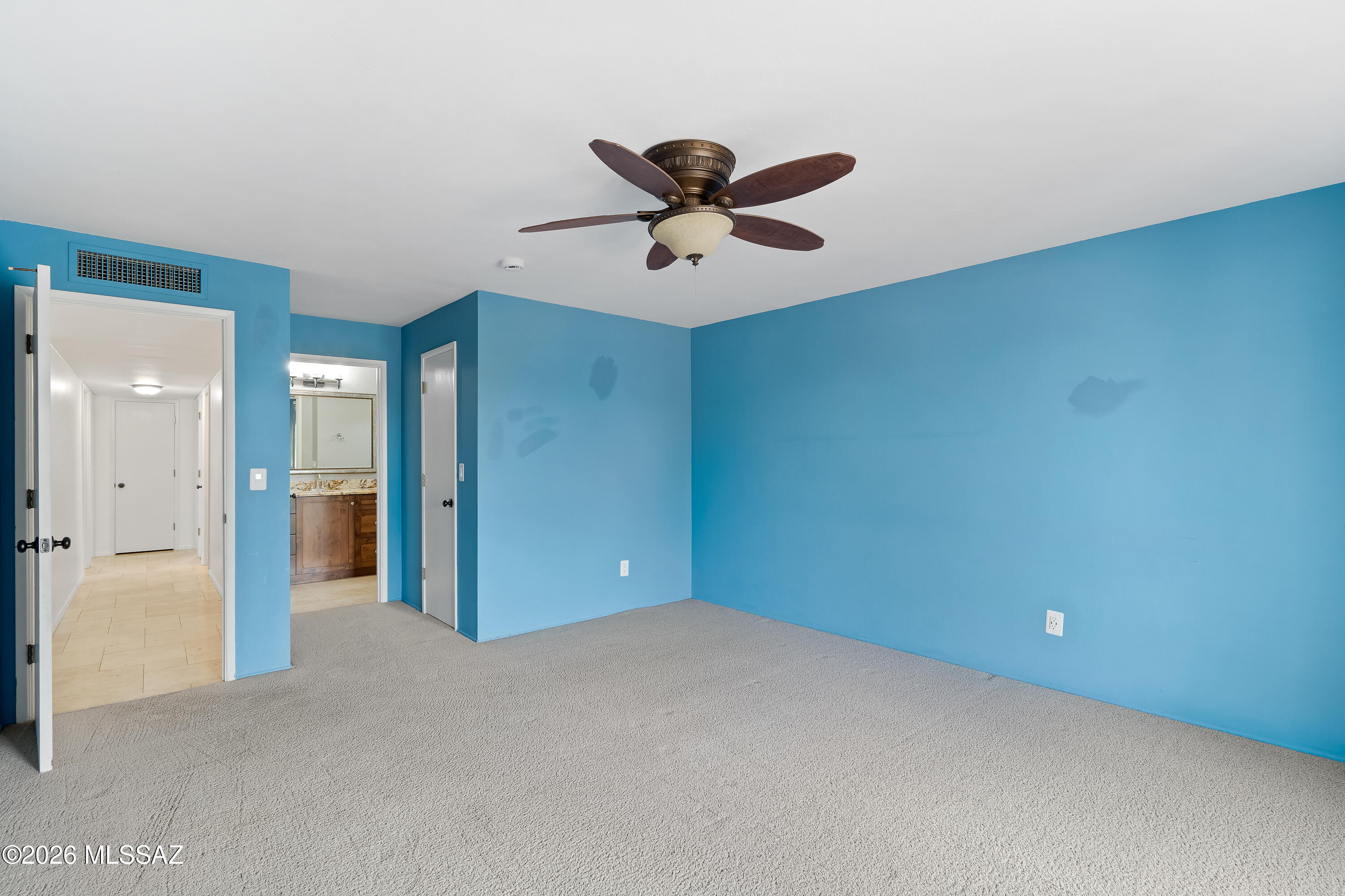 9420 East Ravine Trail Tucson, AZ 85749 - Photo 16 of 39 a view of a big room with a ceiling fan and a window
