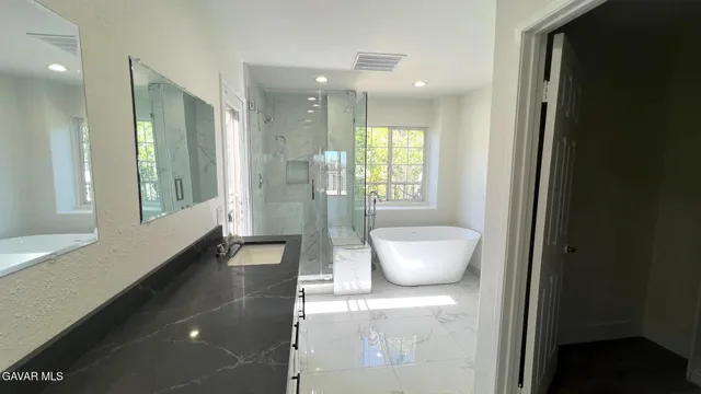 a bathroom with a bathtub and a shower