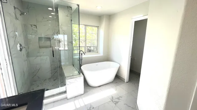 a bathroom with a bathtub and shower