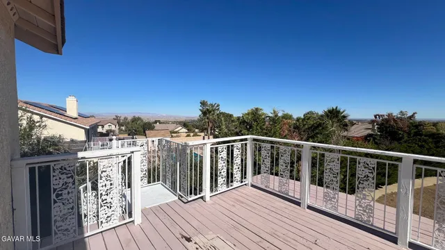 a view of a balcony with wooden floor