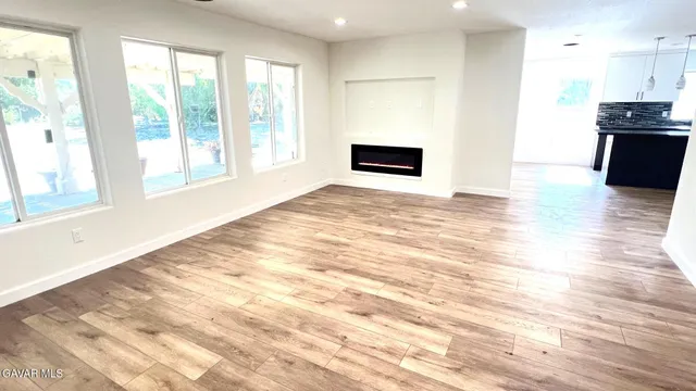 a view of kitchen with kitchen island microwave and stove top oven