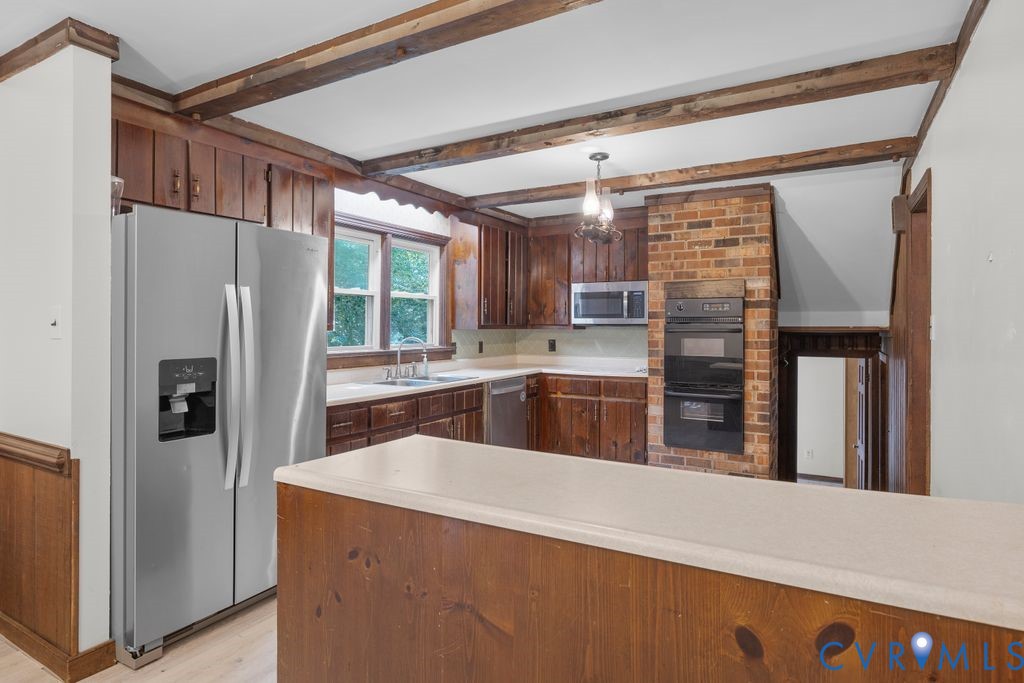 16064 Binns Road Doswell, VA 23047 - Photo 12 of 35 a kitchen with granite countertop a refrigerator and a sink