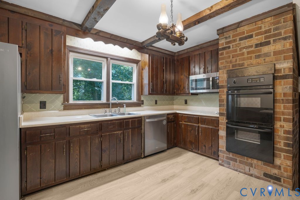 16064 Binns Road Doswell, VA 23047 - Photo 13 of 35 a kitchen with stainless steel appliances granite countertop a sink and stove