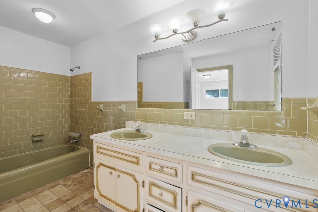 16064 Binns Road Doswell, VA 23047 - Photo 24 of 35 a bathroom with a sink double vanity granite tub shower and a mirror