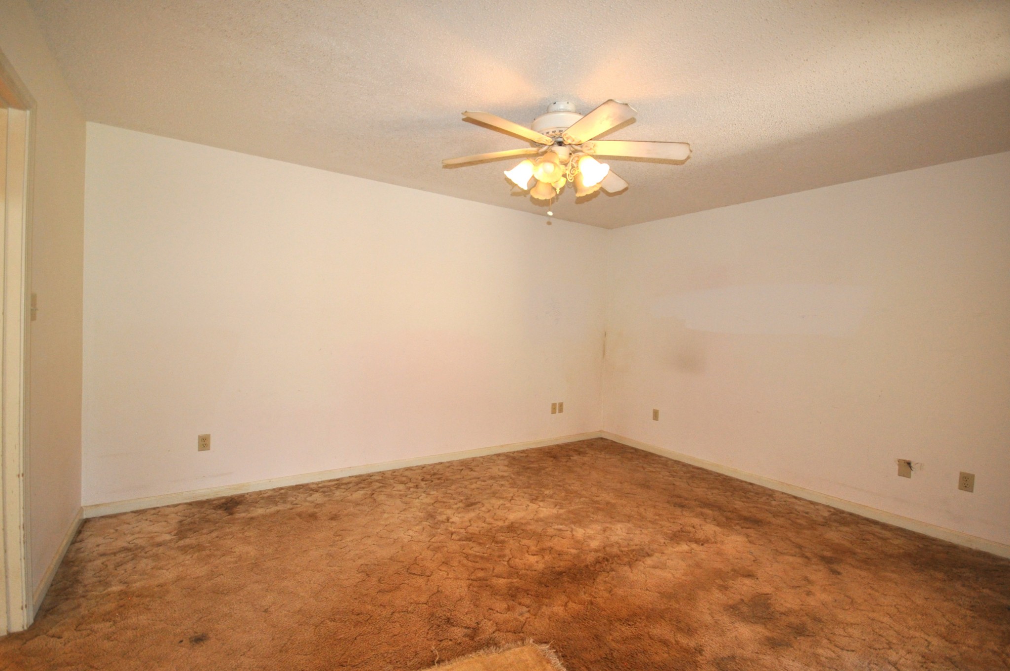 5620 Sango Road Cedar Hill, TN 37032 - Photo 21 of 37 an empty room with a chandelier fan and wooden floor