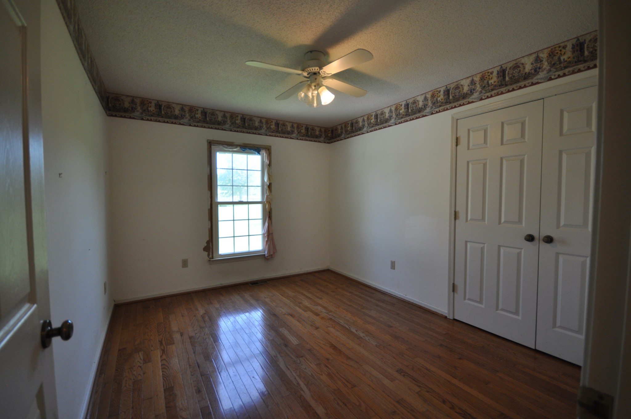 5620 Sango Road Cedar Hill, TN 37032 - Photo 25 of 37 a view of an empty room with wooden floor and a window