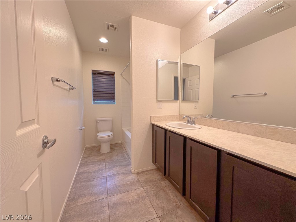 10934 Ketchikan Street Las Vegas, NV 89179 - Photo 13 of 30 Bathroom with vanity, bathtub / shower combination, and light tile patterned floors