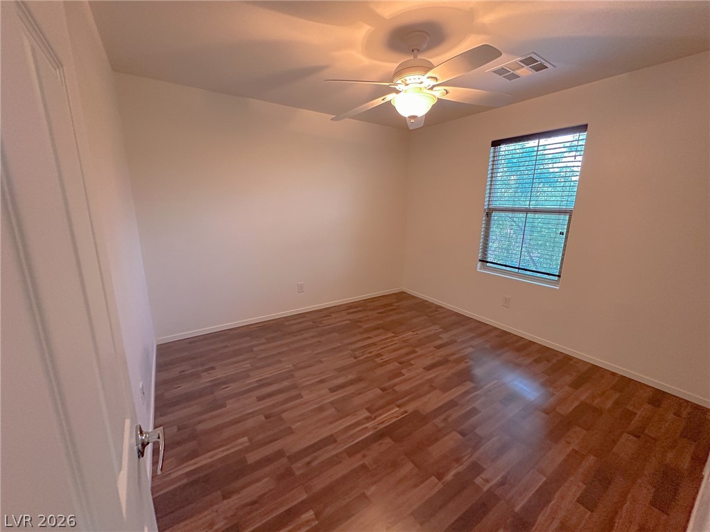 10934 Ketchikan Street Las Vegas, NV 89179 - Photo 16 of 30 Unfurnished room with dark wood finished floors and a ceiling fan