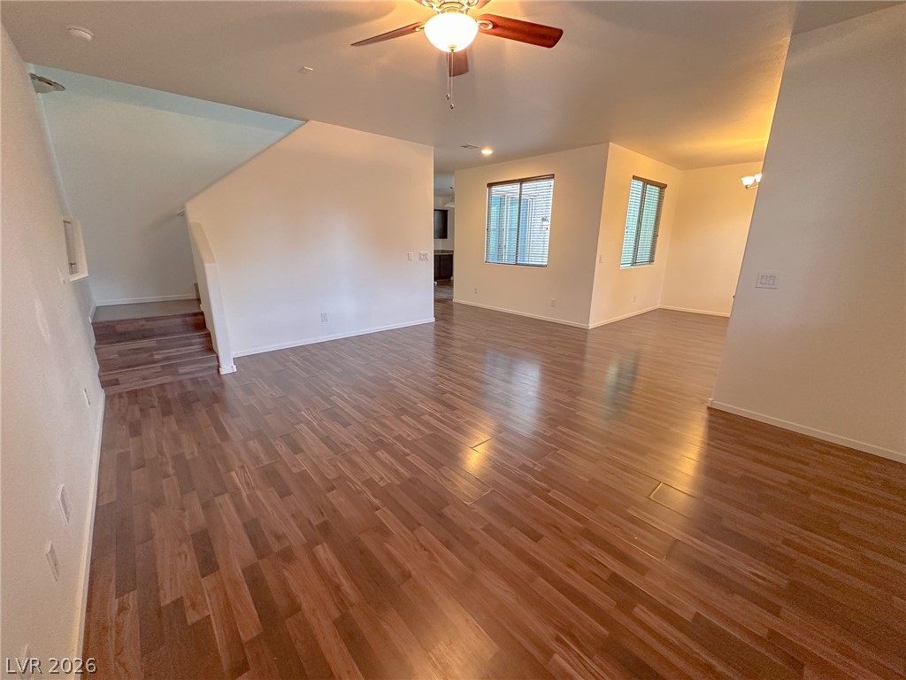 10934 Ketchikan Street Las Vegas, NV 89179 - Photo 19 of 30 Unfurnished living room featuring dark wood-style flooring and ceiling fan