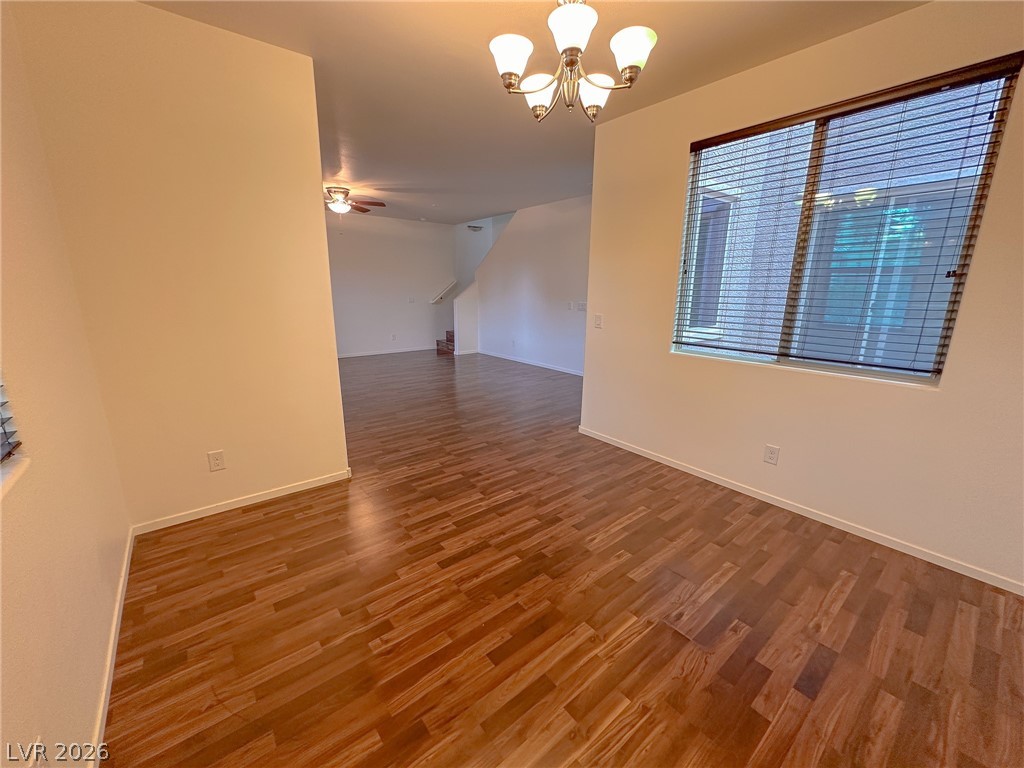 10934 Ketchikan Street Las Vegas, NV 89179 - Photo 21 of 30 Spare room featuring suspended lighting, dark wood-style floors, and a ceiling fan