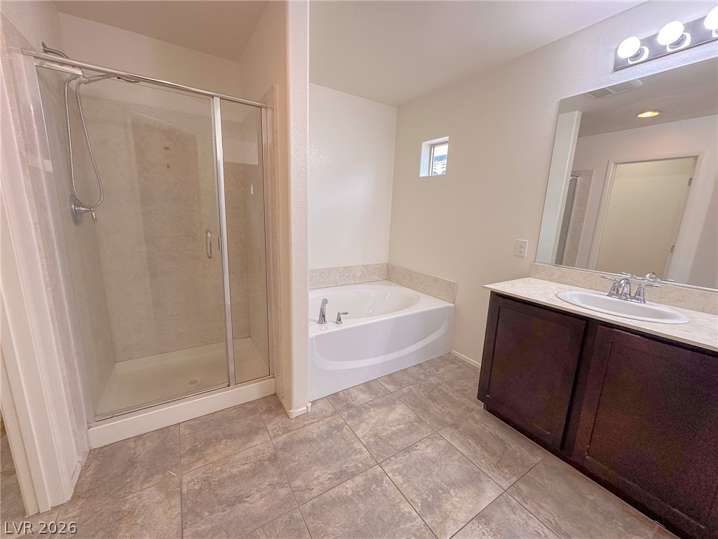 10934 Ketchikan Street Las Vegas, NV 89179 - Photo 7 of 30 Bathroom with vanity, a bath, and a stall shower