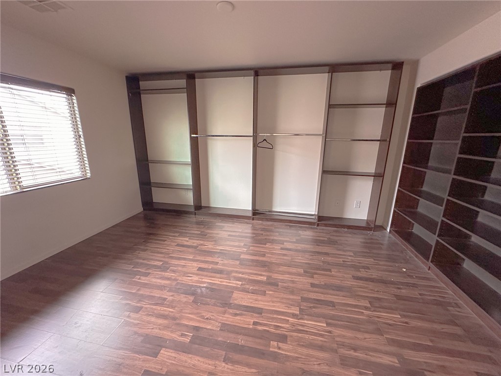 10934 Ketchikan Street Las Vegas, NV 89179 - Photo 8 of 30 Unfurnished bedroom with dark wood-style floors and a closet