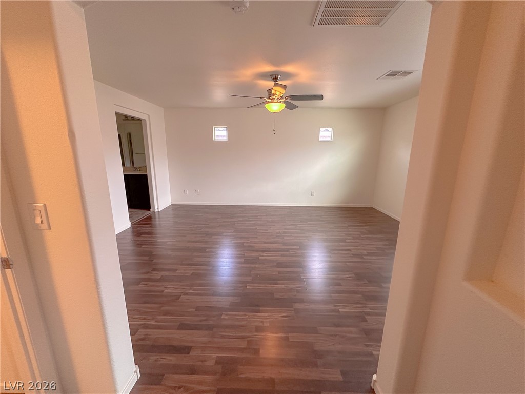 10934 Ketchikan Street Las Vegas, NV 89179 - Photo 10 of 30 Spare room featuring dark wood-type flooring and ceiling fan