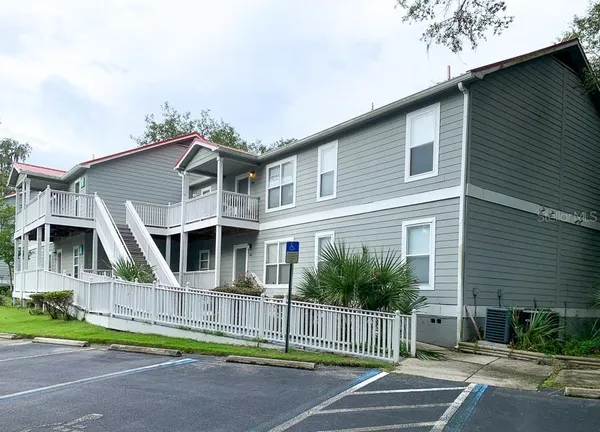 a front view of a house with a garden and plants
