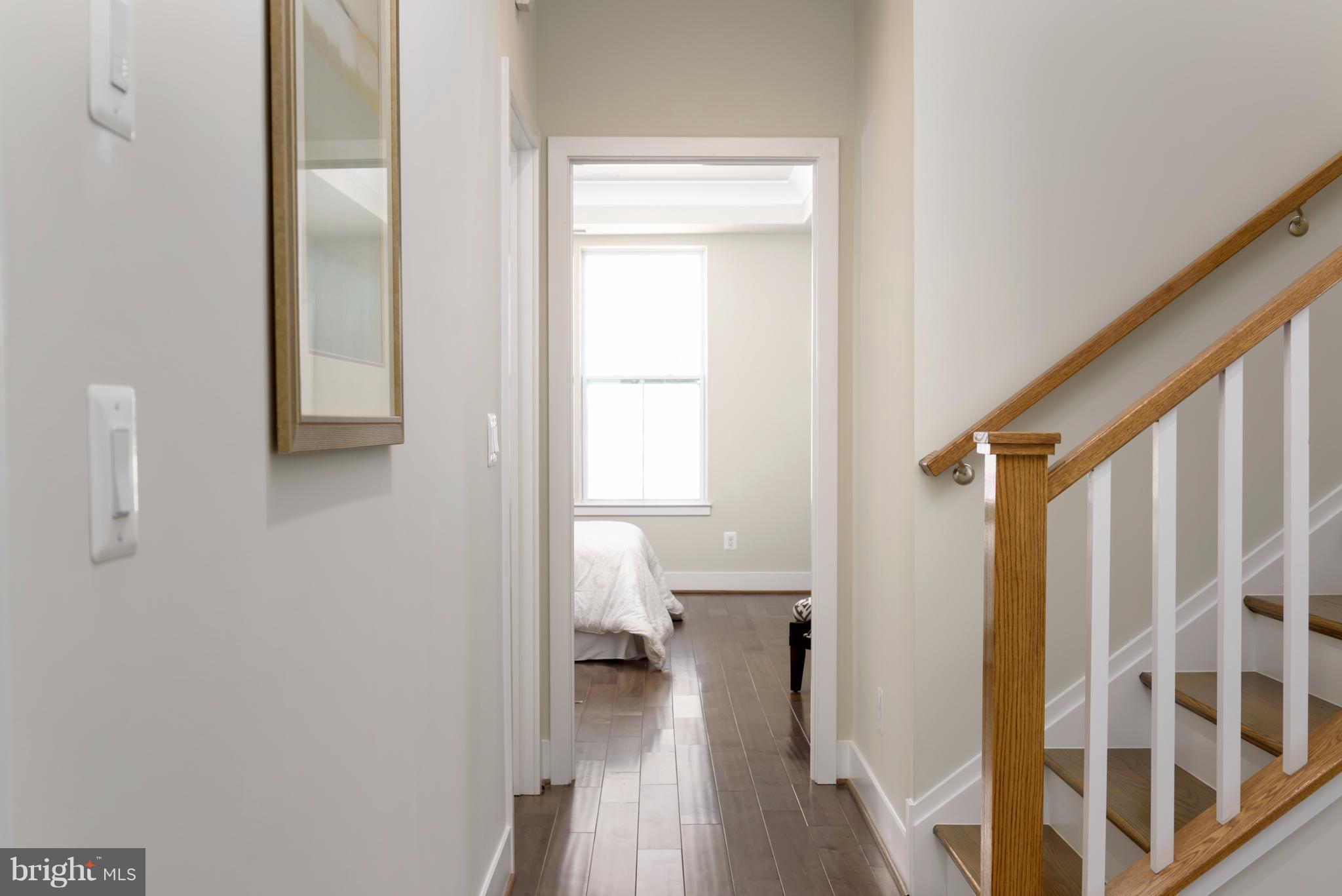 1985 Roland Clarke Place Reston, VA 20191 - Photo 11 of 24 a view of a hallway with wooden floor and stairs