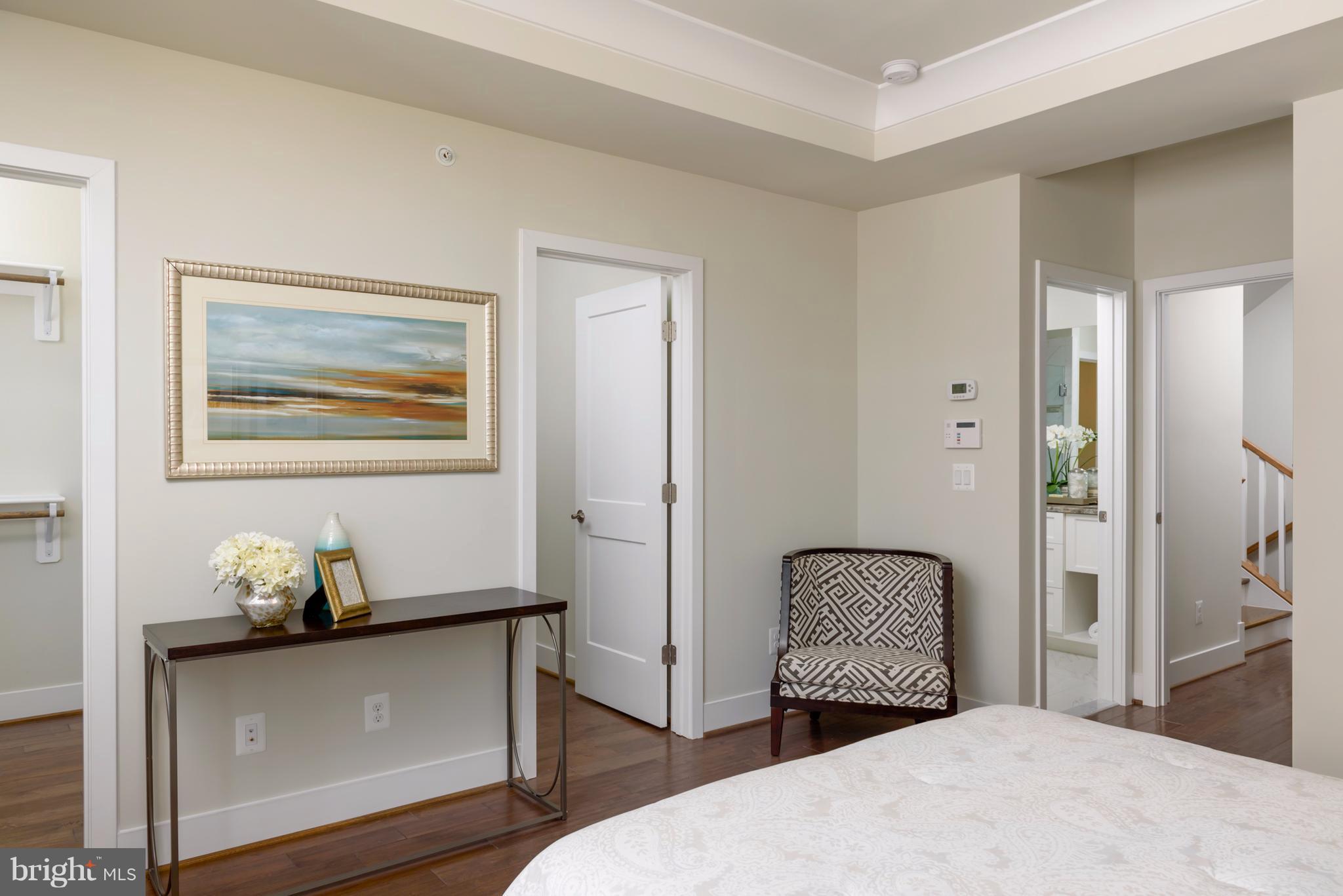 1985 Roland Clarke Place Reston, VA 20191 - Photo 13 of 24 a bedroom with a bed and wooden floor