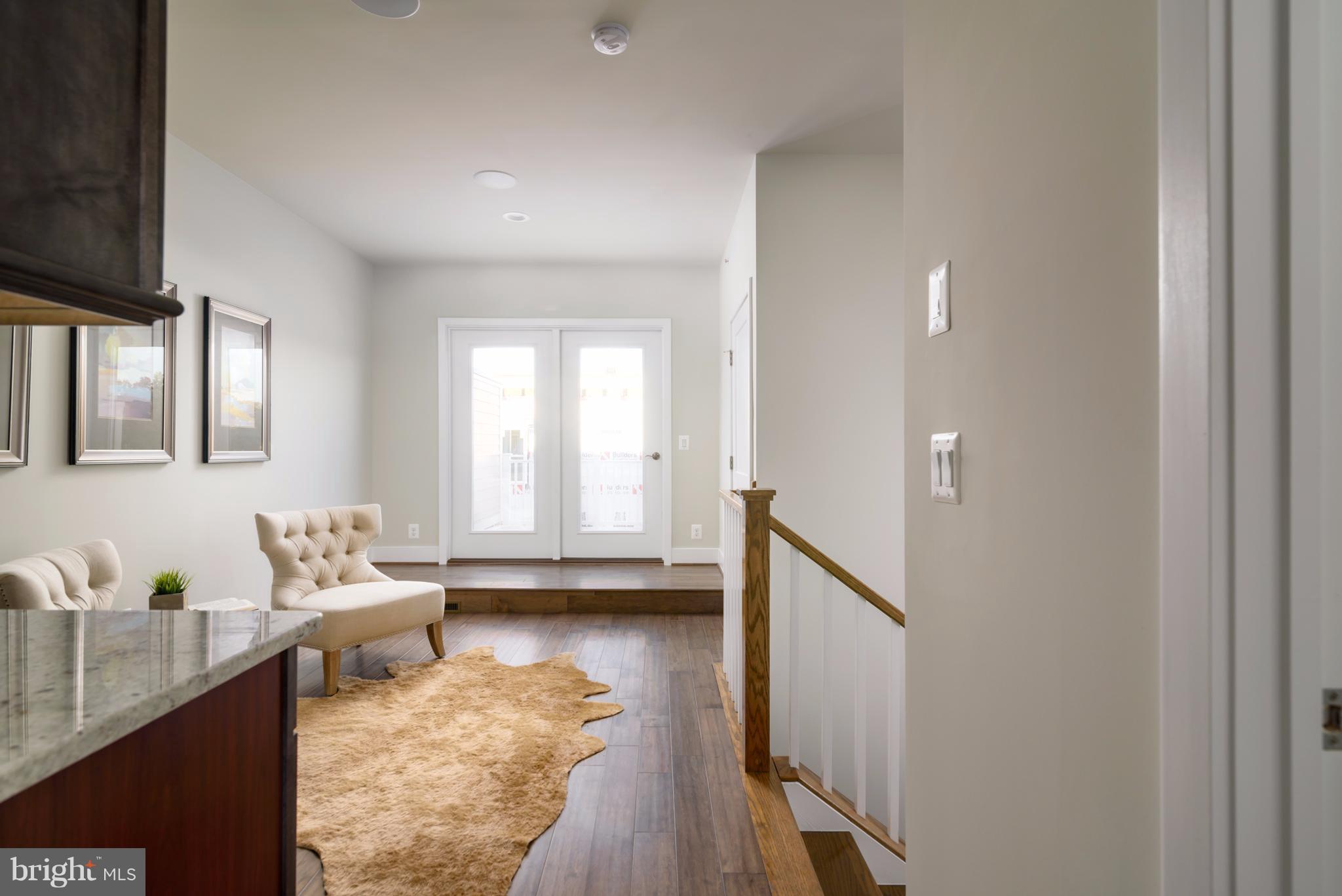 1985 Roland Clarke Place Reston, VA 20191 - Photo 18 of 24 a living room with furniture and a wooden floor