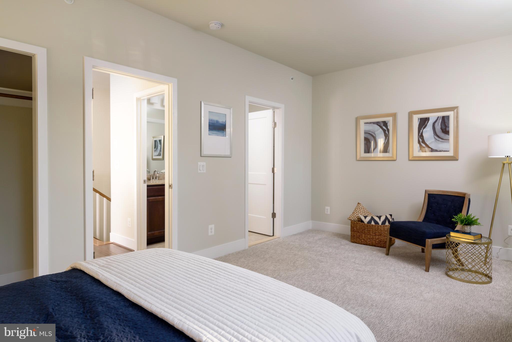 1985 Roland Clarke Place Reston, VA 20191 - Photo 21 of 24 a bedroom with a bed and a chair