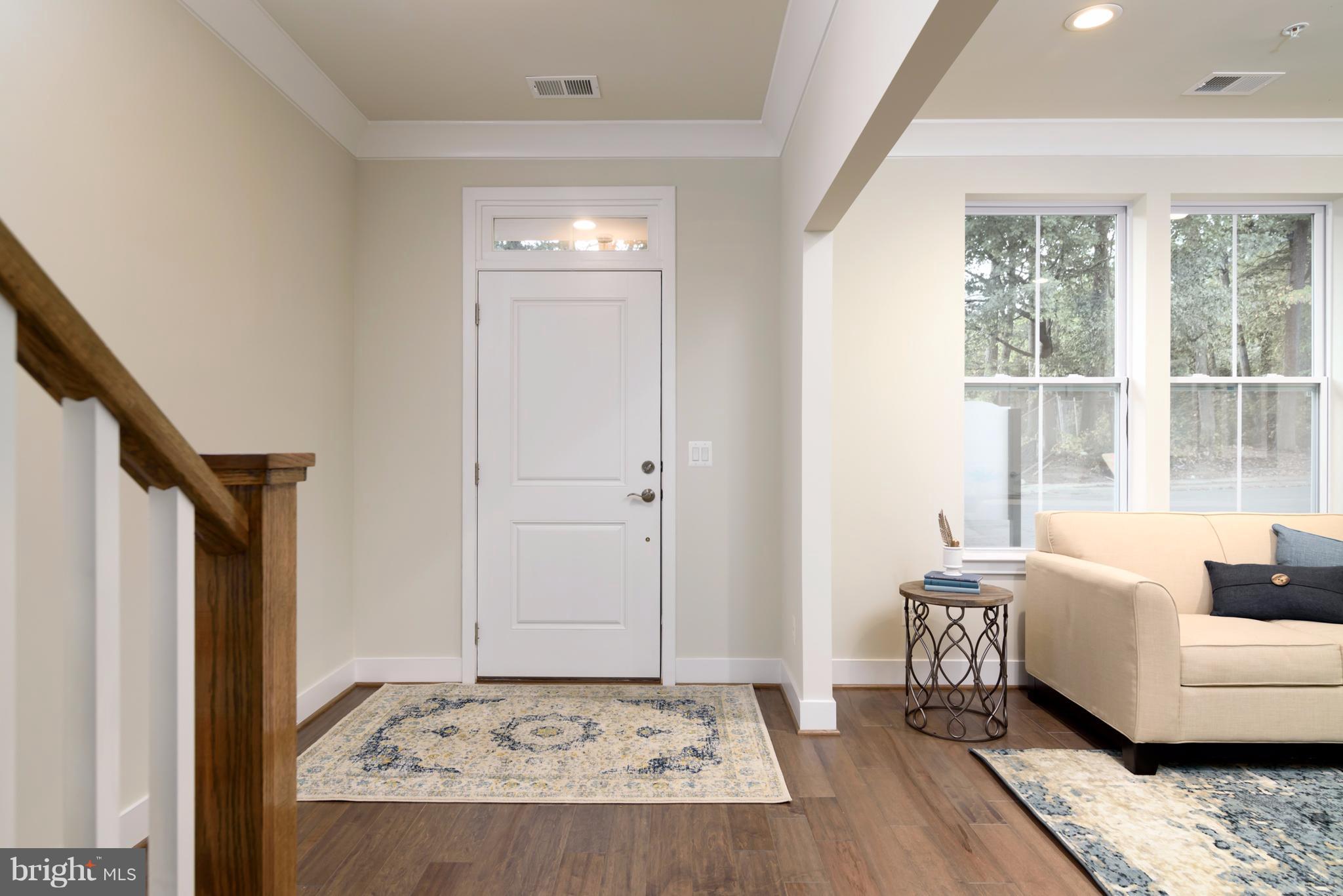 1985 Roland Clarke Place Reston, VA 20191 - Photo 4 of 24 a living room with furniture and a rug