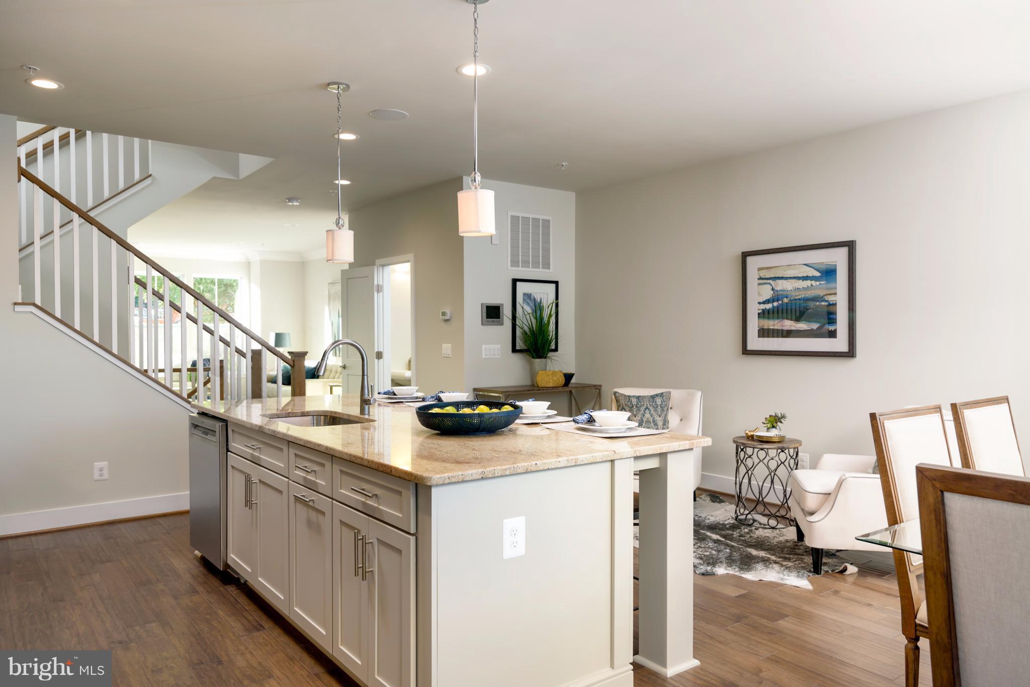 1985 Roland Clarke Place Reston, VA 20191 - Photo 10 of 24 a kitchen with sink a mirror and a view of living room
