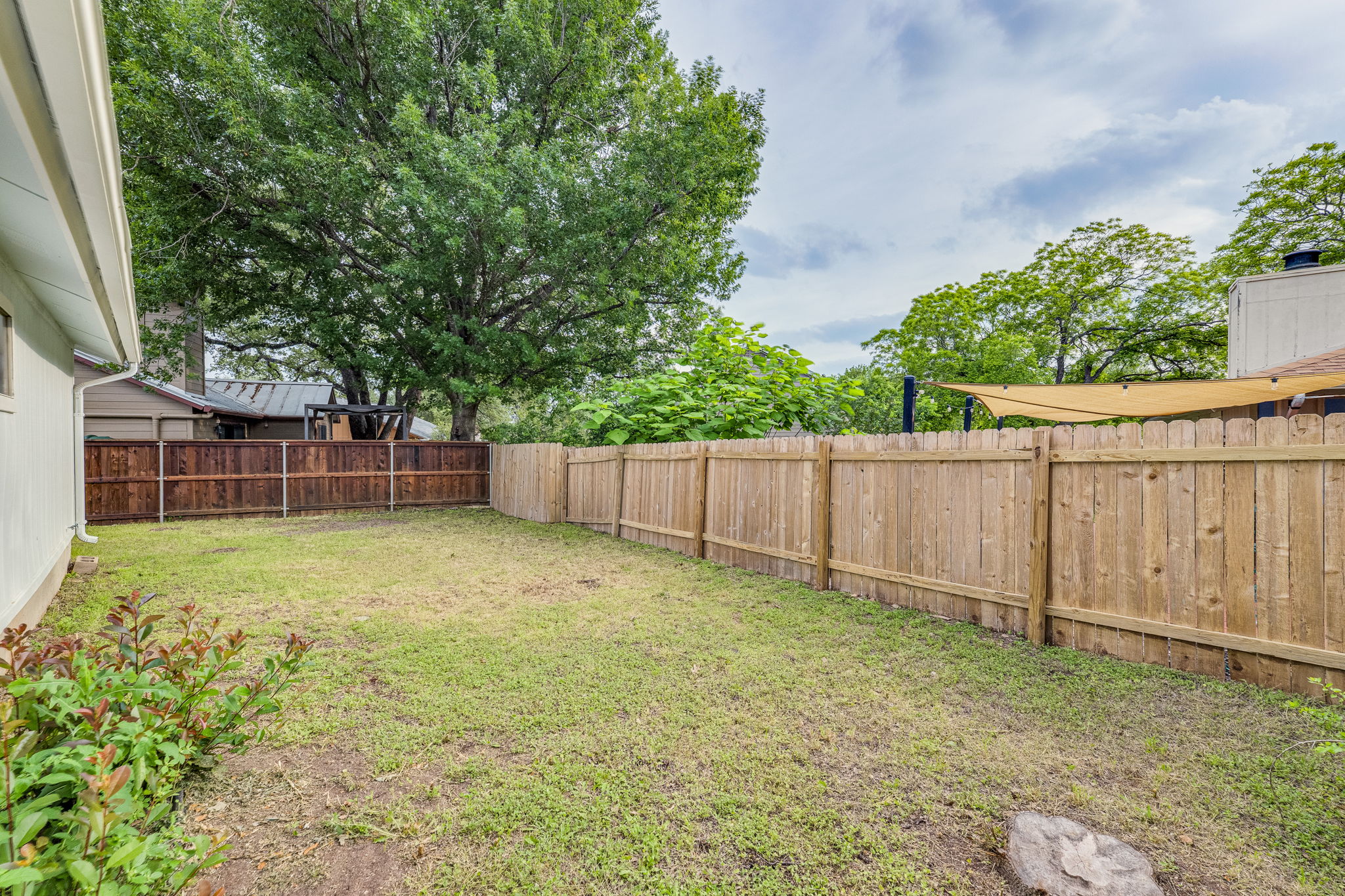 4815 Transit Circle Austin, TX 78727 - Photo 29 of 35 Expansive backyard featuring a wood privacy fence... Are you ready to host everything from peaceful morning coffee to questionable weekend DIY projects.