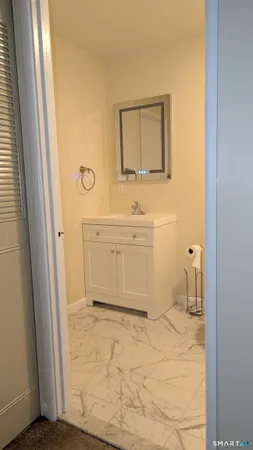 a bathroom with a sink a mirror and a toilet