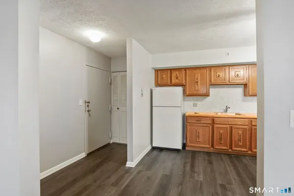 a view of kitchen with a sink dishwasher and a refrigerator