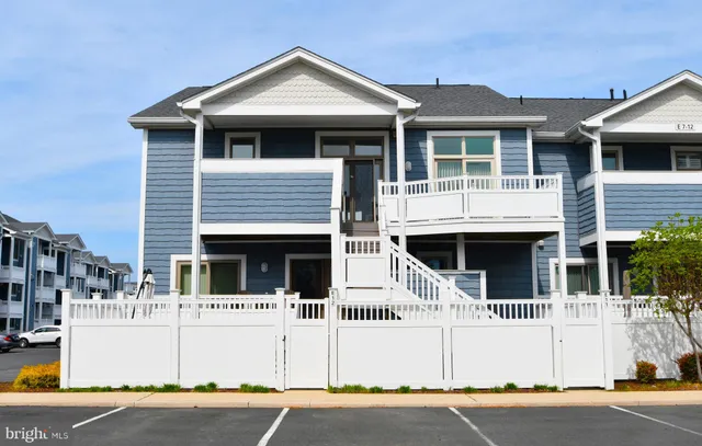 a view of a swimming pool with a yard and plants