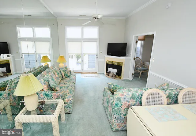 a living room with furniture a flat screen tv and a dining table