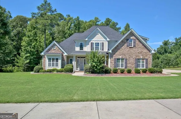 a front view of a house with a yard