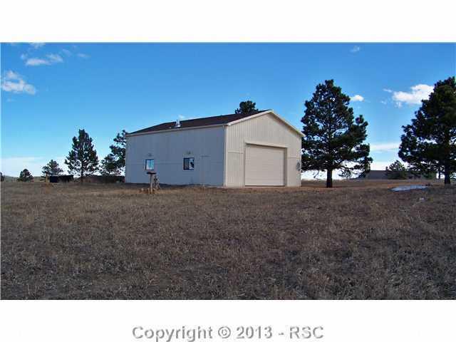 Backside of Detached garage has a separate chicken coop area with built in nesting boxes and concrete floor...