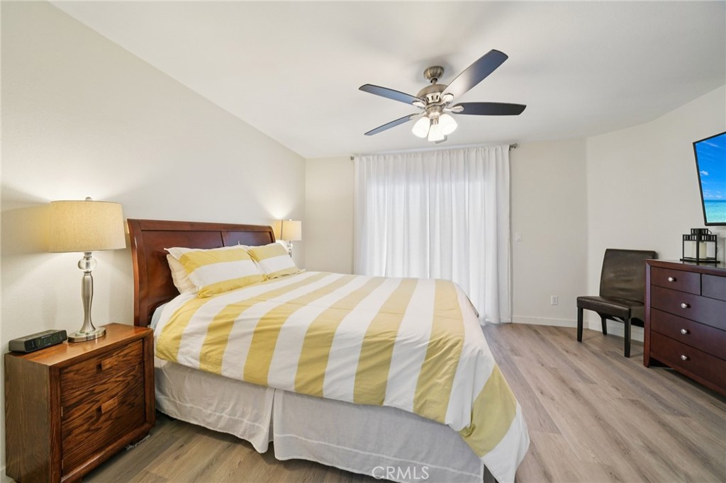 56 Dearborn Circle Redlands, CA 92374 - Photo 23 of 50 a bedroom with a bed and wooden floor