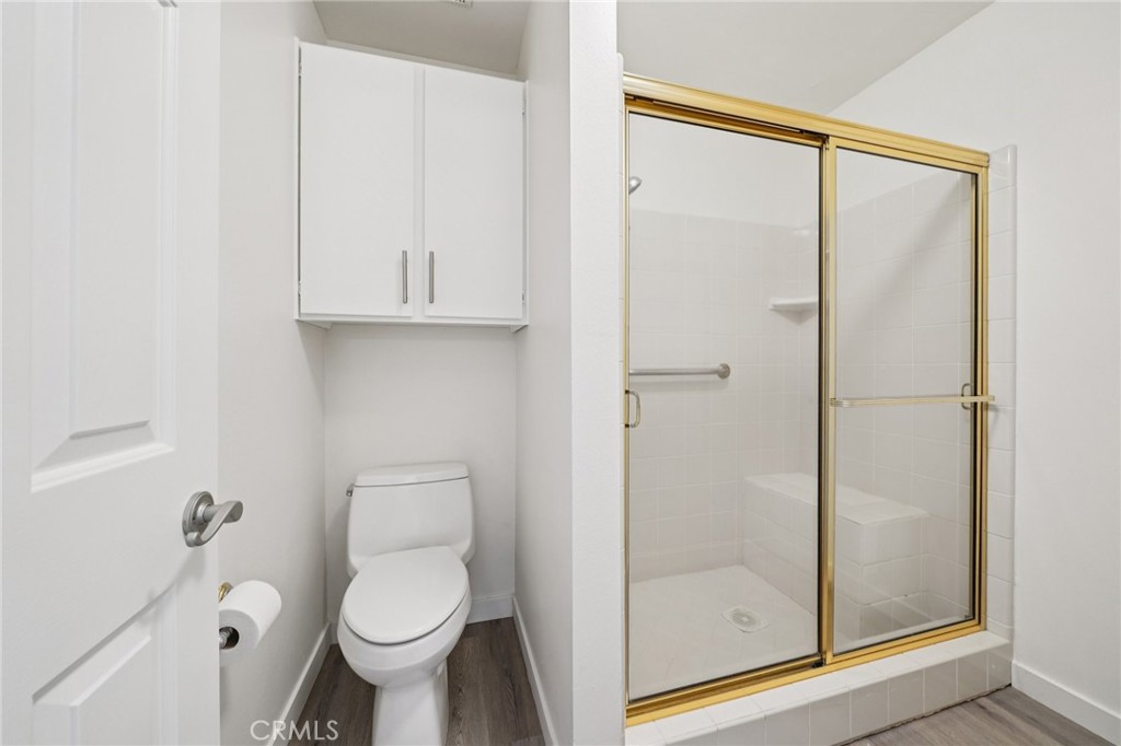 56 Dearborn Circle Redlands, CA 92374 - Photo 26 of 50 a bathroom with a toilet and a shower