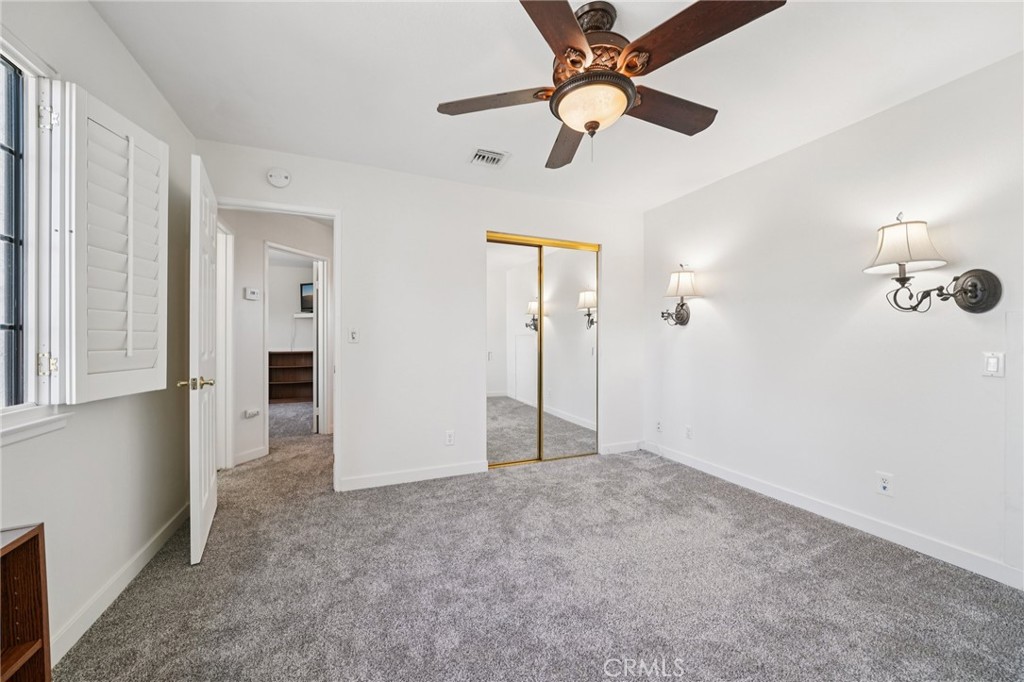56 Dearborn Circle Redlands, CA 92374 - Photo 33 of 50 wooden floor in an empty room with a chandelier fan