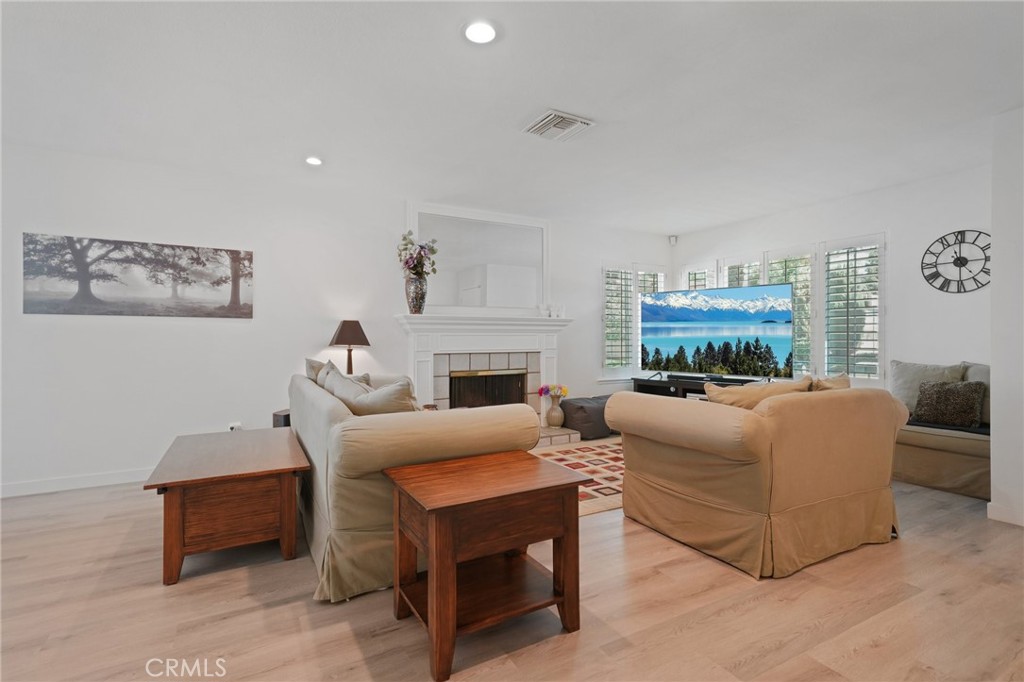 56 Dearborn Circle Redlands, CA 92374 - Photo 5 of 50 a living room with furniture a fireplace and a table