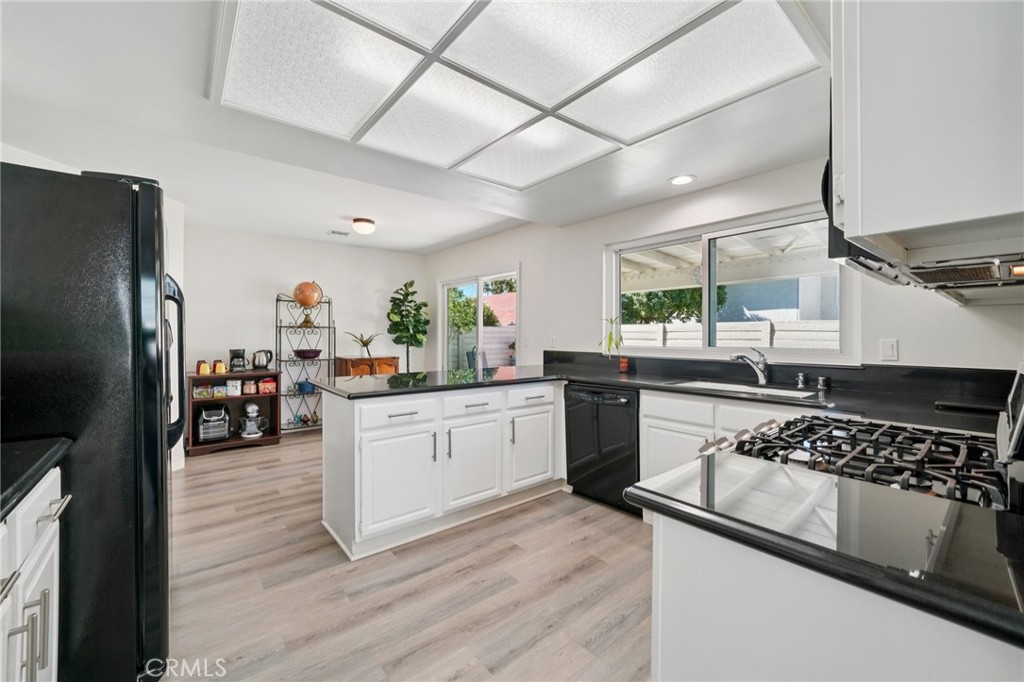 56 Dearborn Circle Redlands, CA 92374 - Photo 9 of 50 a kitchen with stainless steel appliances granite countertop a lot of counter space and wooden floors