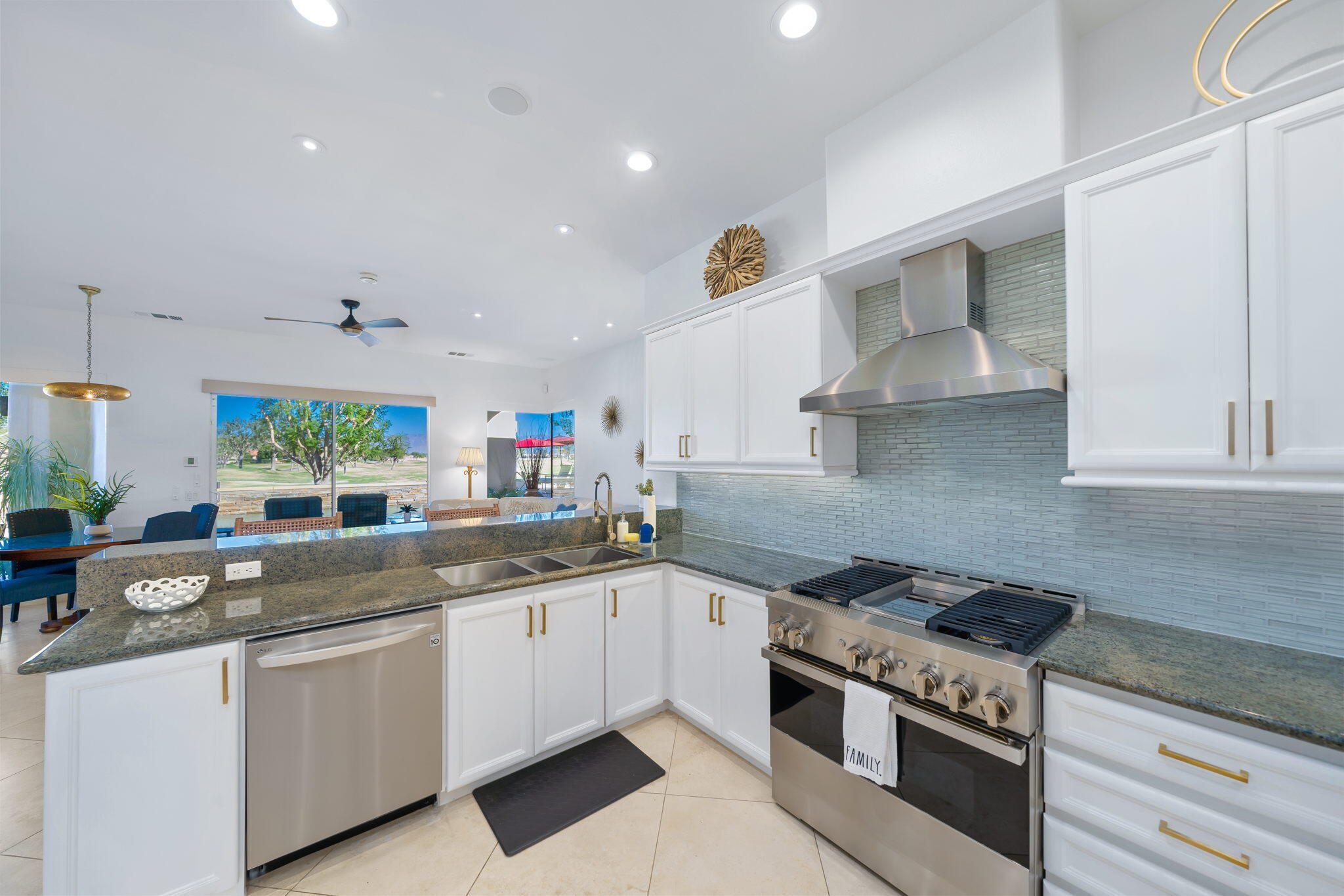 80128 Riviera La Quinta, CA 92253 - Photo 15 of 33 a kitchen with a sink stove top oven and cabinets
